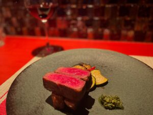 Plated lean Wagyu steak served at QUNIOMI in Tokyo, paired with seasonal vegetables