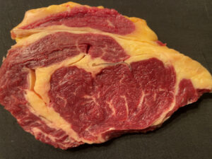 Lean cut of Wagyu beef showing deep red muscle and minimal marbling