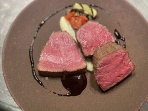 Lean Akaushi Wagyu steak served with French-style sauce and vegetables