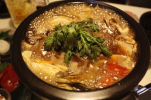 Kanto-style Wagyu sukiyaki hot pot with vegetables simmering in a sweet soy-based broth. 