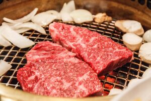 Sliced Wagyu beef for yakiniku grilling with mushrooms and onion