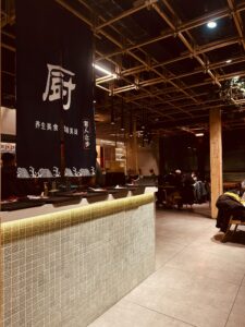 Interior of a quiet Japanese restaurant with wooden tables, representing a calm Wagyu dining atmosphere in Tokyo. 